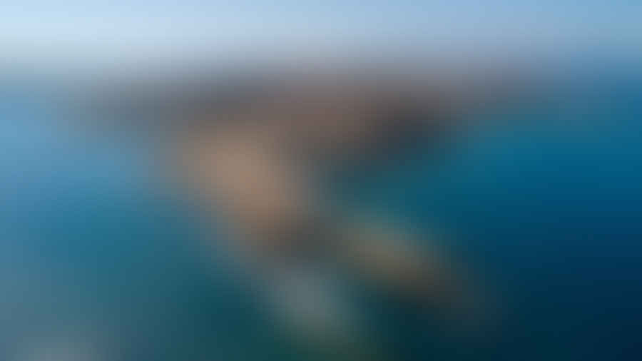 Breathtaking panoramic view of a secluded Greek island surrounded by azure waters